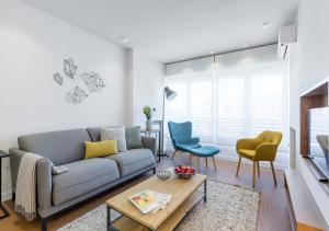 a living room with a couch and two chairs at Francisco Silvela Apartment by Flatsweethome in Madrid