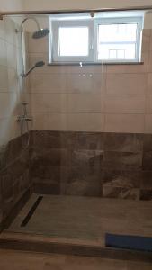 a shower with a glass door in a bathroom at Sea Sound Apartment Mamaia Nord in Mamaia Sat/Năvodari +49 photos
