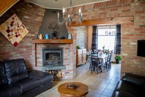 a living room with a couch and a fireplace at The BlackSmith's House in Libin