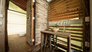 a bathroom with a sink in a wooden wall at La pajarera in Mazunte