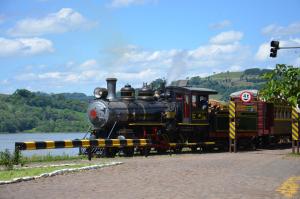 an old train on a track next to a river at Paraiso das Aguas in Marcelino Ramos