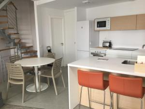 a kitchen and dining room with a table and chairs at AMAZING DUPLEX on the beach in El Médano