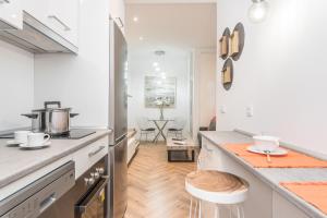 a kitchen with a refrigerator and a counter top at BNBHolder Cute MALASAÑA in Madrid