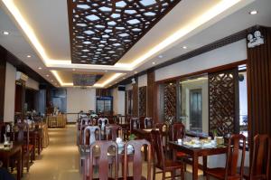a restaurant with tables and chairs in a room at Phu Tho Hotel in Ho Chi Minh City