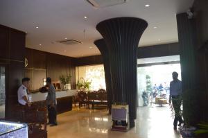 a group of people standing in a lobby at Phu Tho Hotel in Ho Chi Minh City