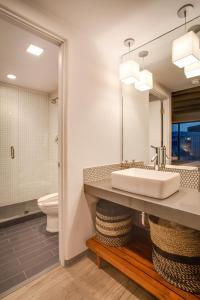 a bathroom with a sink and a toilet at El Vado Motel in Albuquerque +8 photos