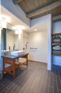 a bathroom with a tub and a sink and a mirror at El Vado Motel in Albuquerque