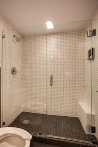 
a bathroom with a shower stall and a toilet at El Vado Motel in Albuquerque
