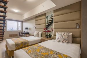 En eller flere senge i et værelse på Hotel Kimberly Manila