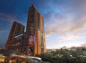 a tall building with a train in front of it at Comfort Service Apartment at Times Square KL in Kuala Lumpur