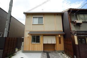 a house with a fence in front of it at Guest House Keiten in Kyoto