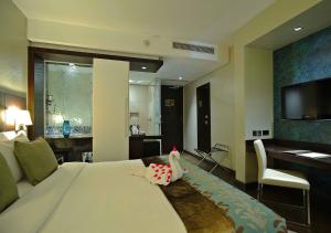 a bedroom with a bed with a stuffed animal on it at Eka Hotel Nairobi in Nairobi