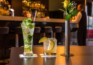two cocktails sitting on a table in a bar at Eka Hotel Nairobi in Nairobi