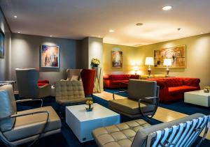 a living room with couches and chairs and a couch at Eka Hotel Nairobi in Nairobi
