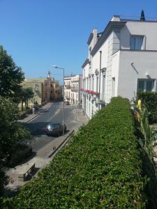 een uitzicht op een straat en een gebouw met een heg bij Villa Avellino Historic Residence in Pozzuoli