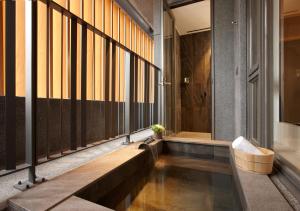 a bathroom with a large tub and a large window at Wellspring by Silks in Jiaoxi