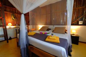 Voodi või voodid majutusasutuse Coco Komba Lodge toas