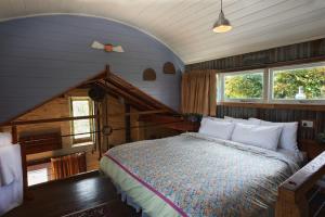 a bedroom with a large bed in a attic at Old Leura Dairy in Leura