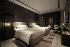 Postelja oz. postelje v sobi nastanitve Yunhe Yebo Hotel (Shanghai International Tourism Resort Pudong Airport)