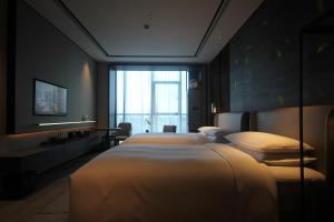 Postelja oz. postelje v sobi nastanitve Yunhe Yebo Hotel (Shanghai International Tourism Resort Pudong Airport)