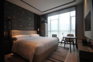 Postelja oz. postelje v sobi nastanitve Yunhe Yebo Hotel (Shanghai International Tourism Resort Pudong Airport)