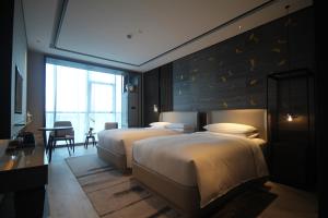 Postelja oz. postelje v sobi nastanitve Yunhe Yebo Hotel (Shanghai International Tourism Resort Pudong Airport)