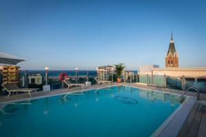 a large swimming pool on the roof of a building at Hotel President in Rimini