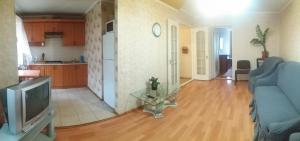 a living room with a blue couch and a television at Two-bedroom apartment on Lenina avenue in Mykolaiv