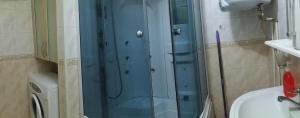 a glass shower in a bathroom with a sink at Трехкомнатная квартира улица Большая Морская 57 in Mykolaiv +15 photos
