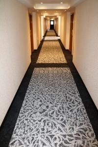 a corridor of a hotel with a carpeted hallway at Hotel Blion Naha in Naha