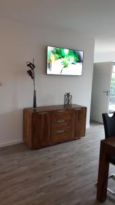 a living room with a tv on a wall at FeWo an der Ostsee Nr. 5 in Rerik