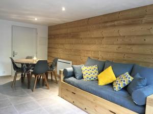 a living room with a blue couch and a table at chez karine et julie in La Rochette