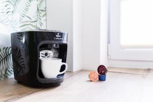 a coffee maker is sitting on the floor next to a door at Apartament Smętka in Olsztyn