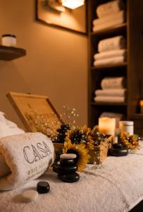 a room with a bed with a pillow and flowers on it at Casa Boutique Hotel in Nahariyya