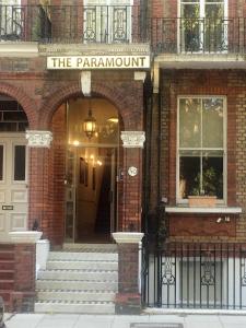 
a brick building with a sign on the front of it at The Paramount Hotel in London
