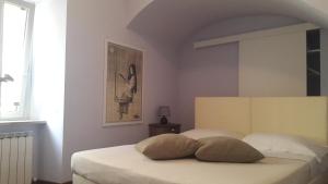 מיטה או מיטות בחדר ב-Il Cortile di San Rufino