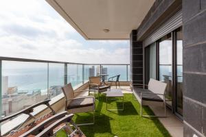 a balcony with chairs and a view of the ocean at Sea View & Sunset in Bat Yam