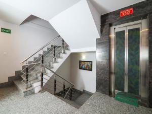 a staircase in a building with a glass door at Hotel Amar International in New Delhi +26 photos