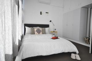 A bed or beds in a room at The One @ Henley Beach