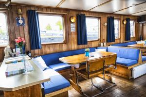 a train car with blue seats and a table at Mps Holland in Amsterdam