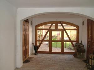 a hallway with a large glass door in a house at Hajós-ház in Szeged