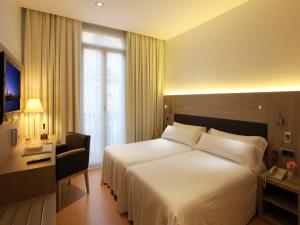 Postel nebo postele na pokoji v ubytování Hotel Lleó