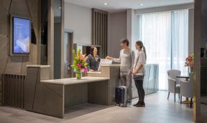 a group of people standing at a reception desk at Maldron Hotel Kevin Street in Dublin