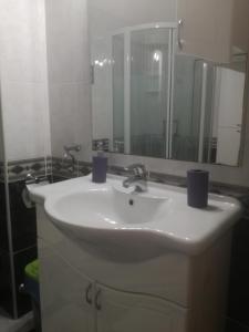 a bathroom with a white sink and a mirror at Apartments Lea in Podstrana