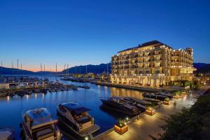 a hotel and boats in a marina at night at Gardelin Apartment in Tivat