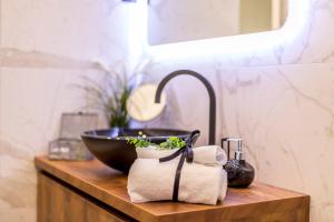 a bathroom counter with a bowl and a sink at Monvi Luxury Suites in Split