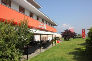 a building with tables and chairs outside of it at Penzión***Q in Zvolen