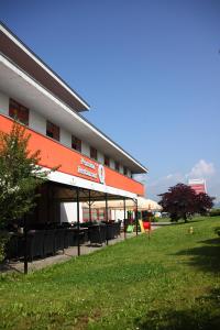 a building with tables and chairs in front of it at Penzión***Q in Zvolen +30 photos