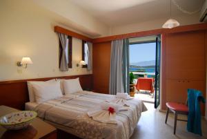 a hotel room with a bed with a flower on it at Lato hotel in Agios Nikolaos