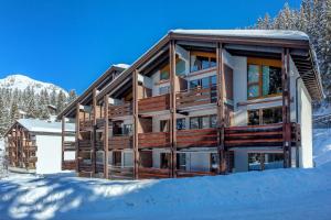 a building with snow in front of it at I dr Rehwiesa A16 in Arosa